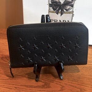 JIMMY CHOO CARNABY ZIP AROUND BLACK WALLET WITH MANY STARS.